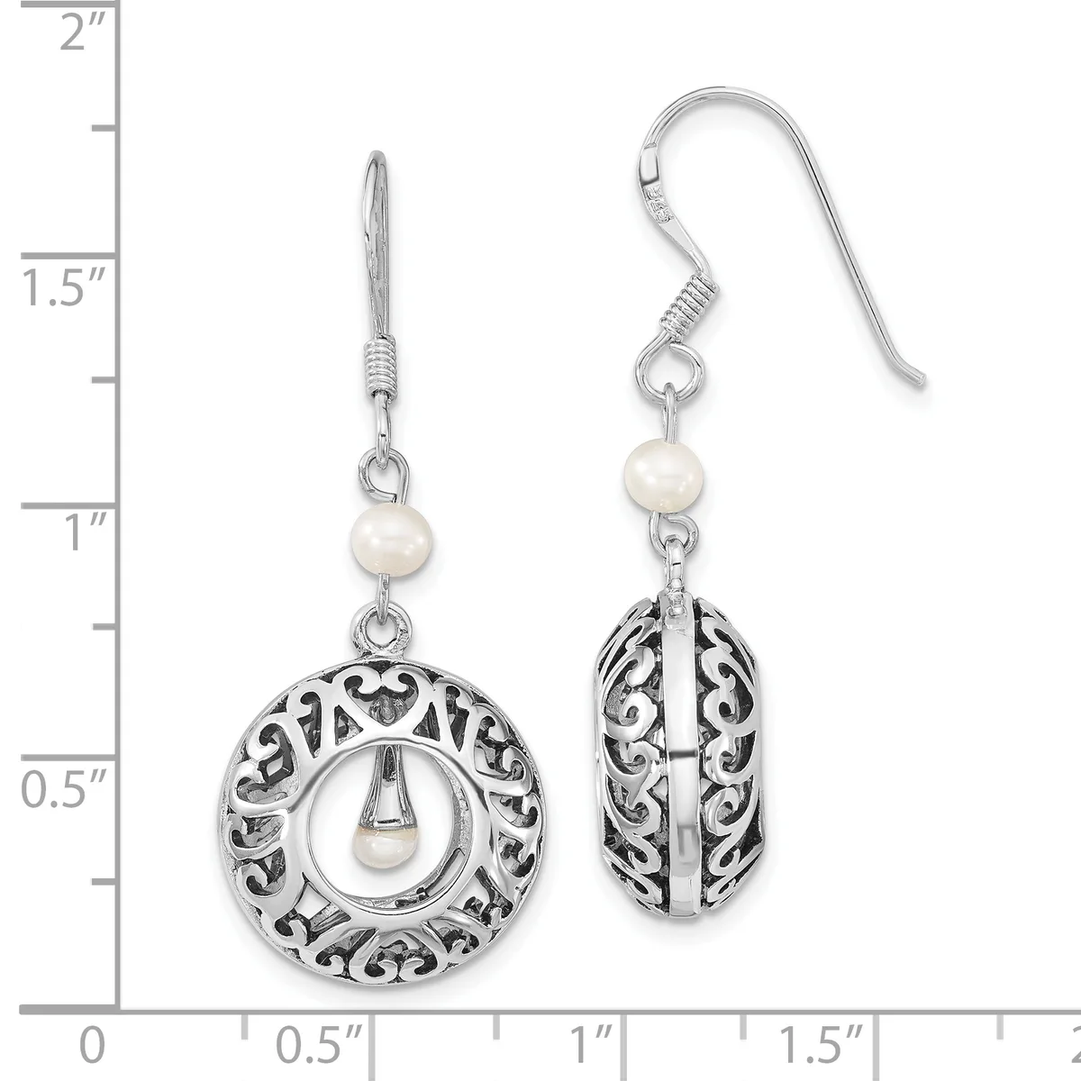 Pair of silver filigree earrings with pearl accents, featuring circular and oval openwork designs, displayed on a measurement scale showing approximately 1.5 inches in length.