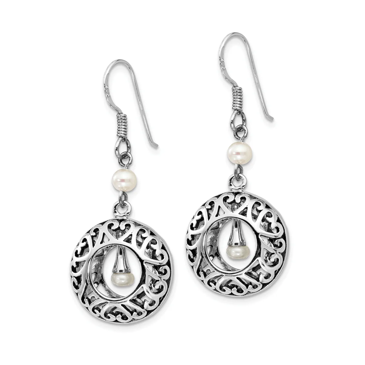A pair of silver dangle earrings with ornate circular filigree pendants each containing a white pearl, suspended from pearl beads on fish hook wires.