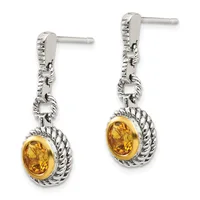 Pair of silver drop earrings with twisted rope-textured bezels surrounding oval yellow citrine stones, suspended from decorative chain links on post backs.