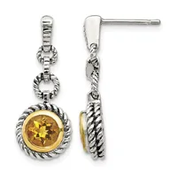 Pair of silver dangle earrings with twisted rope-textured bezels around golden citrine gemstones, shown from front and side views.