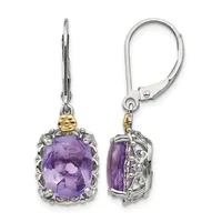 A pair of silver lever-back earrings with cushion-cut purple amethyst stones surrounded by ornate filigree settings and gold-tone accents, shown from front and back views.