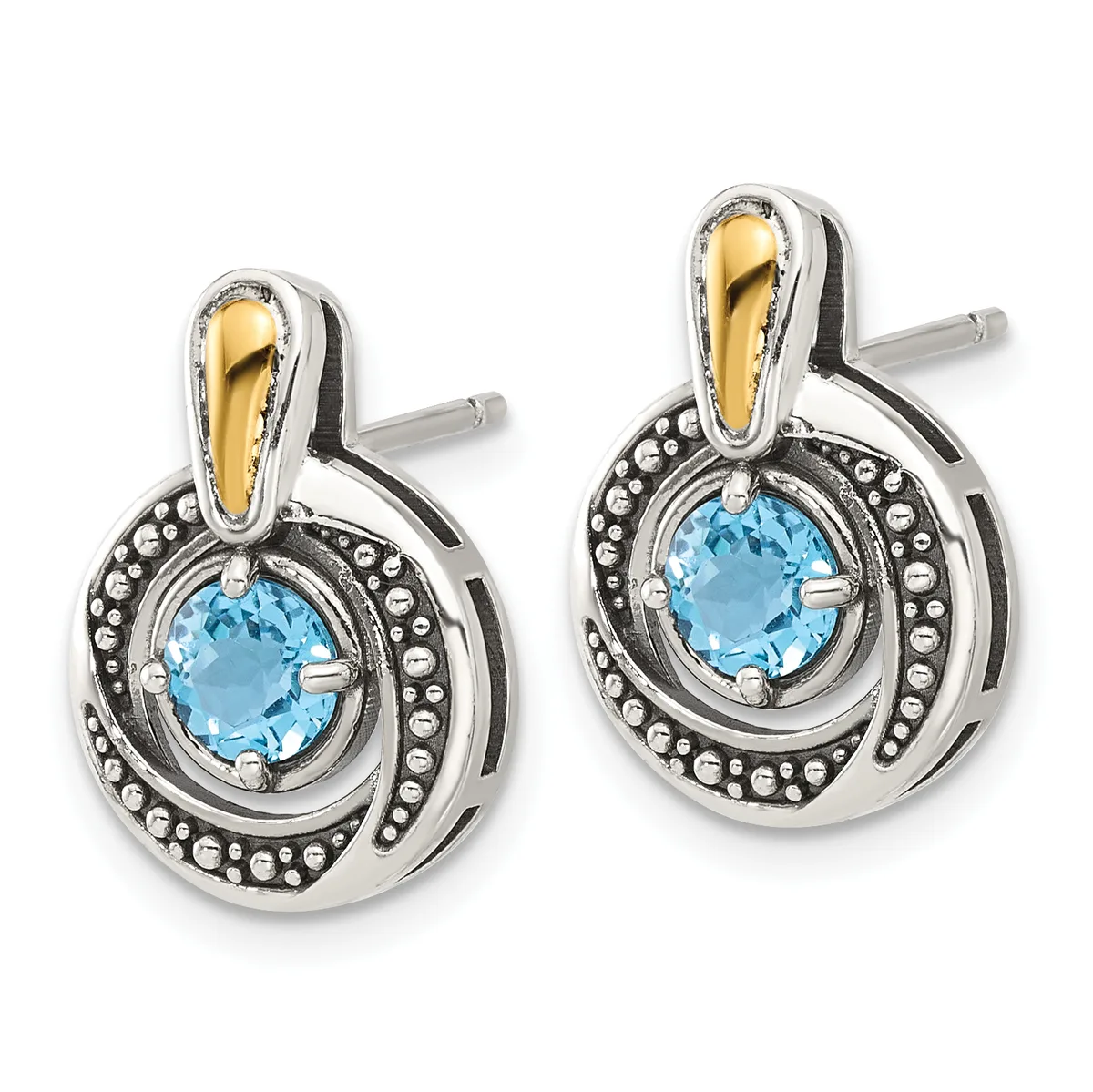 A pair of silver and gold two-tone stud earrings with round blue topaz centers surrounded by beaded borders and curved gold bail tops.