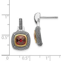 Two views of silver drop earrings with beaded texture, gold-tone bezels, and faceted red gemstone centers, displayed against a measurement scale.