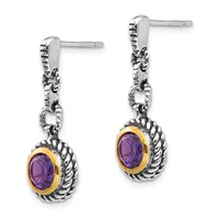 Pair of silver drop earrings with twisted rope detailing and oval purple gemstones set in gold bezels, shown from the front.