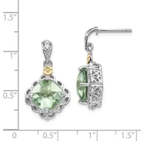A pair of silver and gold dangle earrings with cushion-cut green gemstones surrounded by ornamental filigree details, shown on a measurement scale.