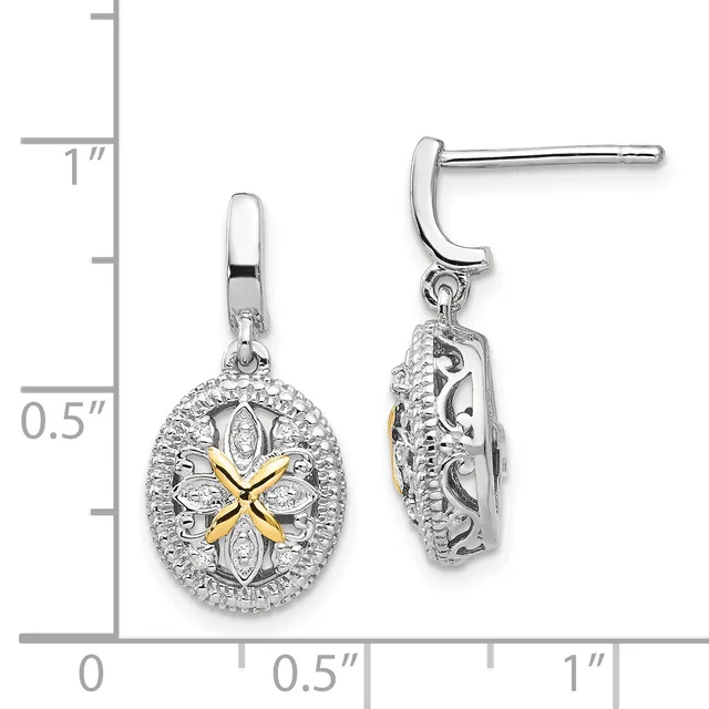 A pair of silver drop earrings with oval pendants featuring a four-pointed star design in gold at the center, surrounded by diamond accents, shown against a measurement scale.