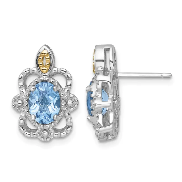 Pair of ornate silver and gold earrings with oval light blue gemstones surrounded by decorative scrollwork, shown from front and side views.