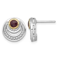 A pair of silver stud earrings with concentric circular designs, featuring a deep red faceted gemstone set in a gold bezel at the center of each earring, shown from front and side views.