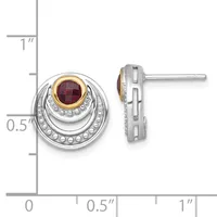 Silver stud earrings with concentric circular design, gold-bezel ruby center stone, and beaded texture, shown front and side view with measurement scale.