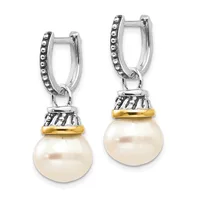A pair of silver hoop earrings with beaded edges, each featuring a decorative gold-toned band and a large round white pearl suspended below.