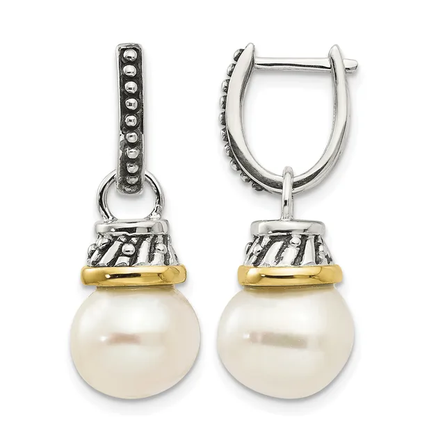 Pair of silver and gold-tone hinge earrings with decorative beaded tops and striped caps suspending white pearl drops.