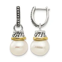 Pair of silver and gold-tone hinge earrings with decorative beaded tops and striped caps suspending white pearl drops.
