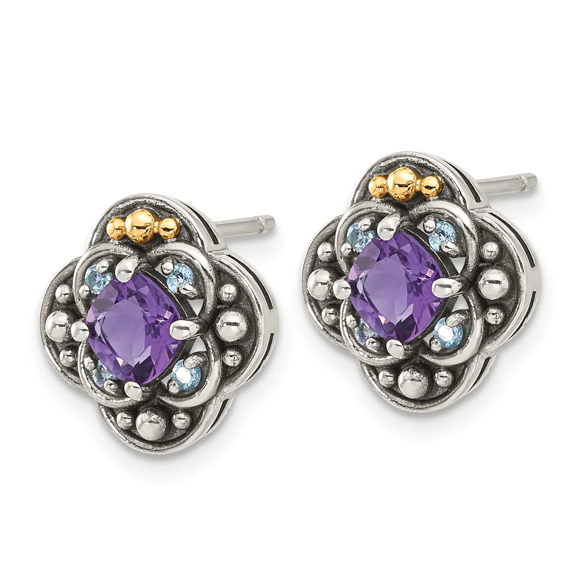 Pair of silver stud earrings with ornate quatrefoil settings featuring central purple amethyst stones surrounded by blue topaz accents and decorative beading, with gold-plated posts.