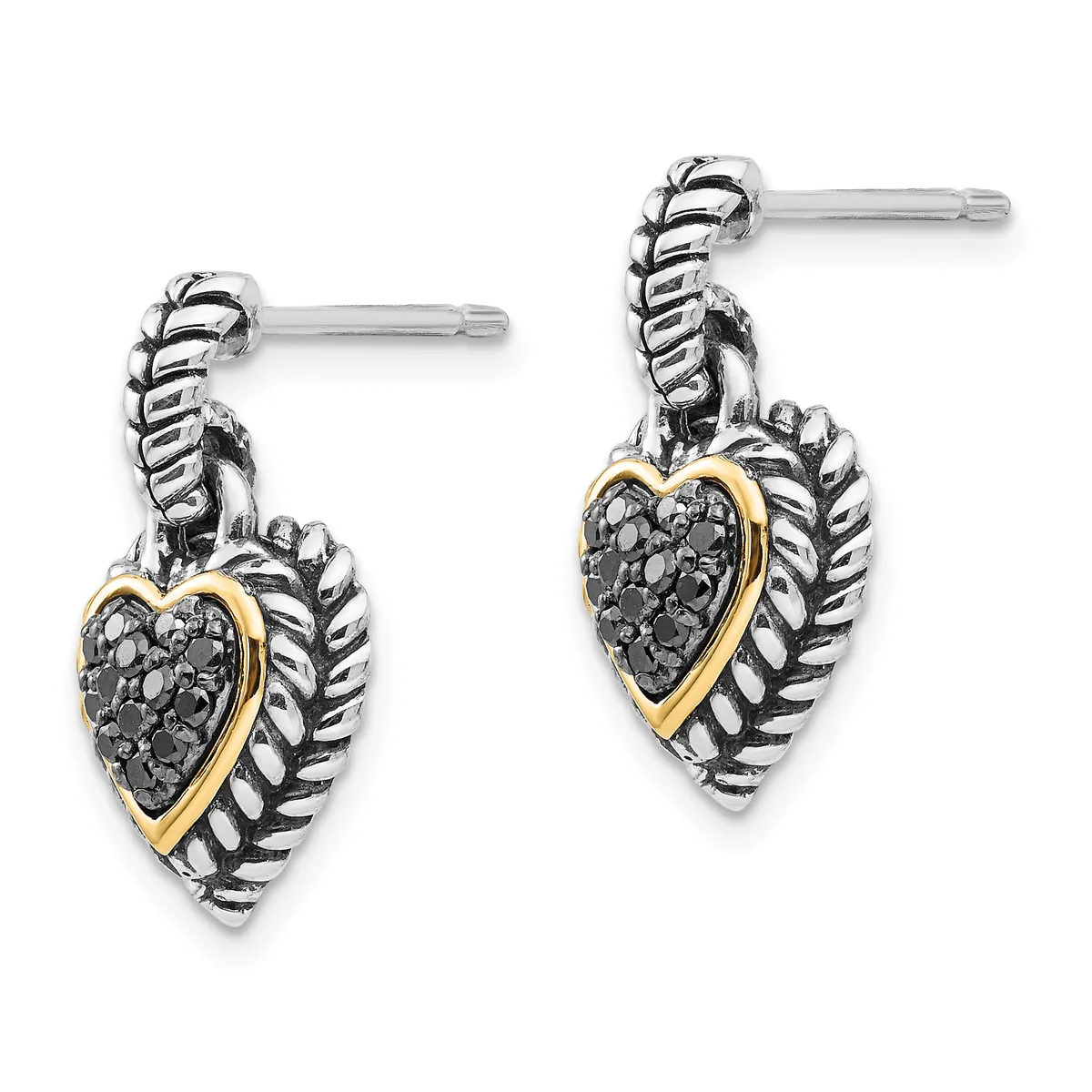 A pair of silver and gold heart-shaped dangle earrings with textured leaf-like frames, set with black stones, displayed against a white background.