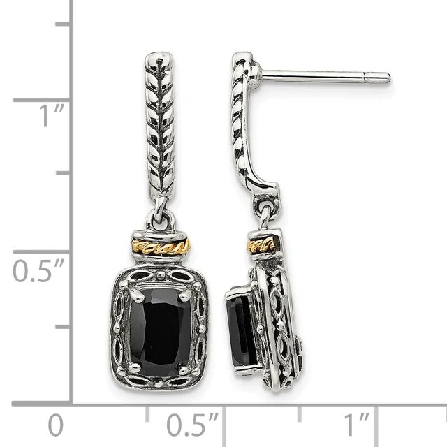 A pair of silver dangle earrings with twisted rope-textured posts, gold-tone spacer bands, and black rectangular gemstone pendants in ornate settings, shown against a measurement scale.