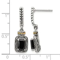 A pair of silver dangle earrings with twisted rope-textured posts, gold-tone spacer bands, and black rectangular gemstone pendants in ornate settings, shown against a measurement scale.