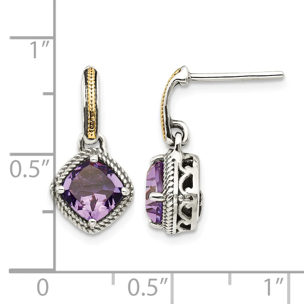 Pair of silver and gold two-tone dangle earrings with cushion-cut purple amethyst stones surrounded by twisted rope detailing, shown next to a ruler.