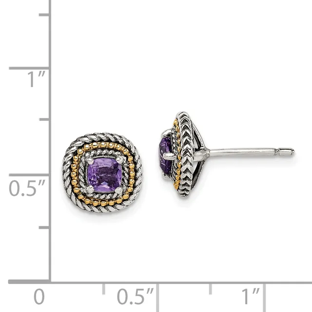 A pair of silver and gold two-tone stud earrings with cushion-cut purple gemstones surrounded by twisted rope detailing, shown against a measurement scale.