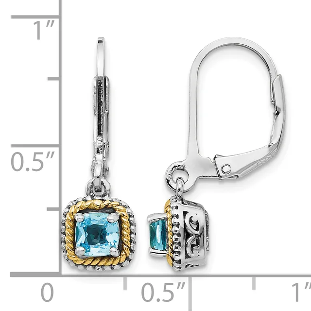 Pair of silver and gold-toned leverback earrings with cushion-cut blue topaz stones, shown next to a ruler measuring approximately one inch in length.