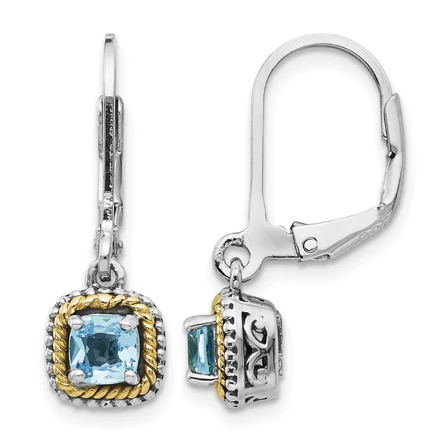 Pair of silver and gold-tone dangle earrings with cushion-cut light blue topaz stones set in ornate square frames, shown from front and side views.