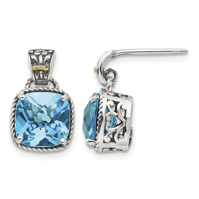 Sterling silver earrings with cushion-cut blue topaz stones set in ornate bezels with rope detailing, shown from front and side views.