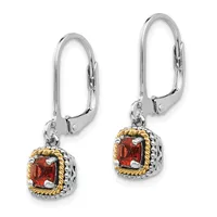 A pair of silver leverback earrings with gold-toned twisted borders, each featuring a square red gemstone in a decorative setting.