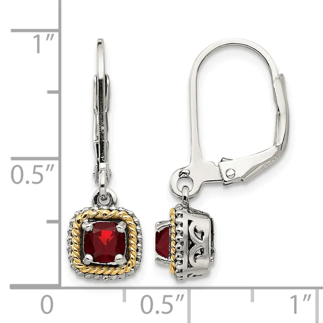 A pair of silver and gold lever-back earrings with square red gemstones in decorative settings, displayed next to a measurement ruler showing approximately one inch in length.