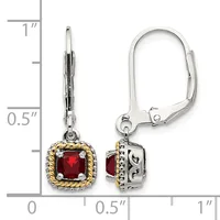A pair of silver and gold lever-back earrings with square red gemstones in decorative settings, displayed next to a measurement ruler showing approximately one inch in length.