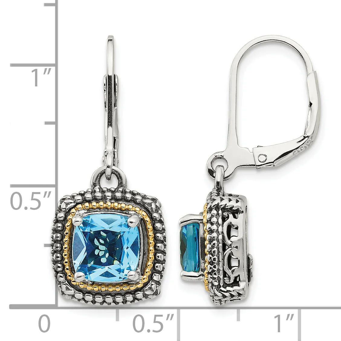Pair of silver lever-back earrings with cushion-cut blue topaz stones surrounded by beaded borders with gold-tone accents, displayed against a measurement scale.