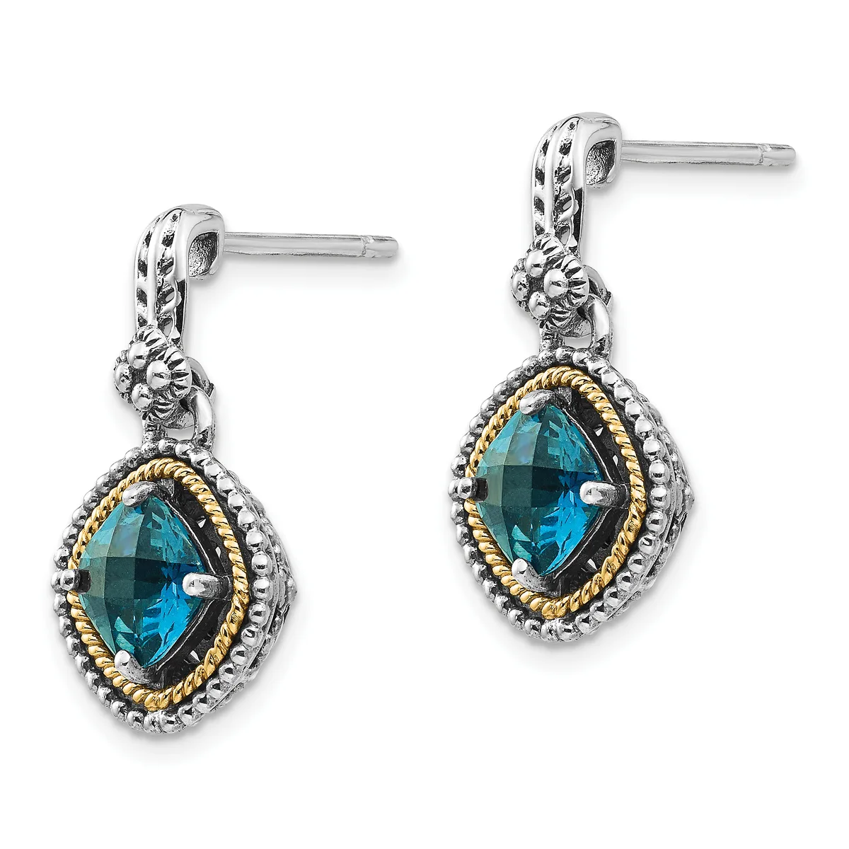 A pair of silver drop earrings with gold-tone twisted rope borders, each featuring a faceted blue topaz stone in an ornate cushion-shaped setting with decorative lion head details above.