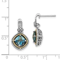 Pair of two-tone drop earrings with cushion-cut blue topaz centers surrounded by twisted gold and silver bands with diamond accents, shown next to a measurement scale.