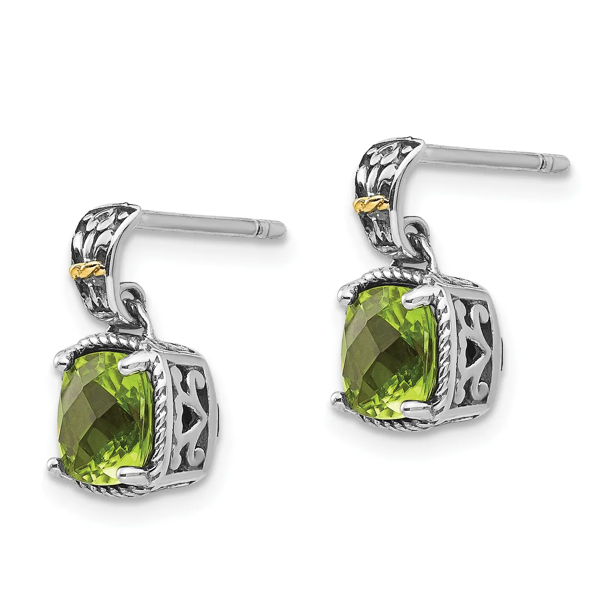 A pair of silver dangle earrings with ornate filigree posts, each featuring a cushion-cut peridot stone in an ornamental square setting with gold accents.