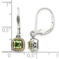 Pair of silver and gold leverback earrings with square green peridot stones set in ornate frames, shown against a ruler measuring approximately one inch in length.