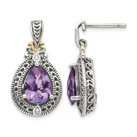Pair of teardrop-shaped sterling silver dangle earrings with faceted purple amethyst centers, ornate filigree frames, small diamond accents, and gold-tone bail details.