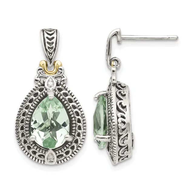 A pair of ornate silver and gold teardrop earrings with green faceted stones surrounded by detailed filigree patterns and small diamond accents, shown from front and side views.