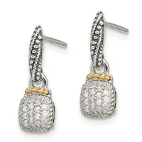 A pair of two-tone silver and gold drop earrings with textured oval posts and cushion-shaped diamond-pave pendants suspended by small gold bands.