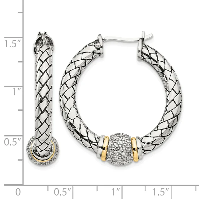 Silver and gold twisted hoop earrings with a diamond-encrusted barrel bead accent, shown on a measurement scale indicating approximately 1.5 inches in length.