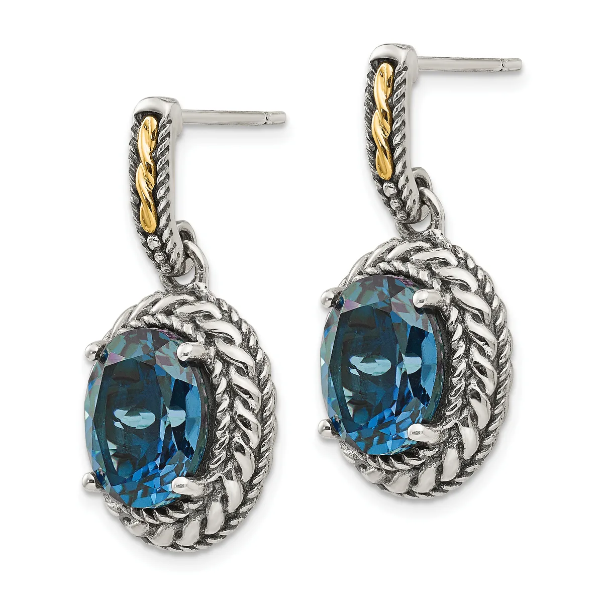 Pair of silver dangle earrings with twisted rope detailing, gold accents on the posts, and oval-cut blue topaz stones set in ornate frames.