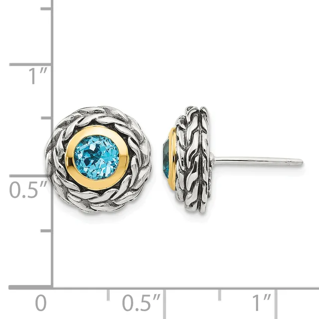 Pair of two-tone stud earrings featuring round blue topaz stones set in gold bezels surrounded by twisted silver rope-textured frames, shown front and side view with a measurement scale.