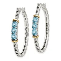 A pair of silver chain hoop earrings with blue topaz gemstones set in gold-tone accents, shown from the front.