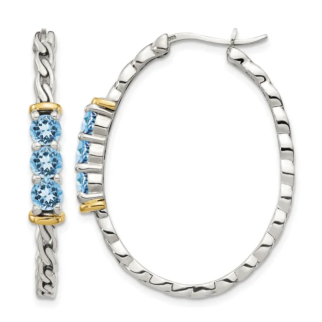A pair of silver hoop earrings with twisted chain design and three round blue gemstones set in gold-toned bezels on each earring.