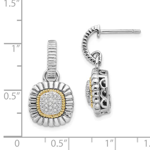 A pair of two-tone silver and gold drop earrings with cushion-shaped diamond centers surrounded by fluted halos, shown next to a measurement ruler.