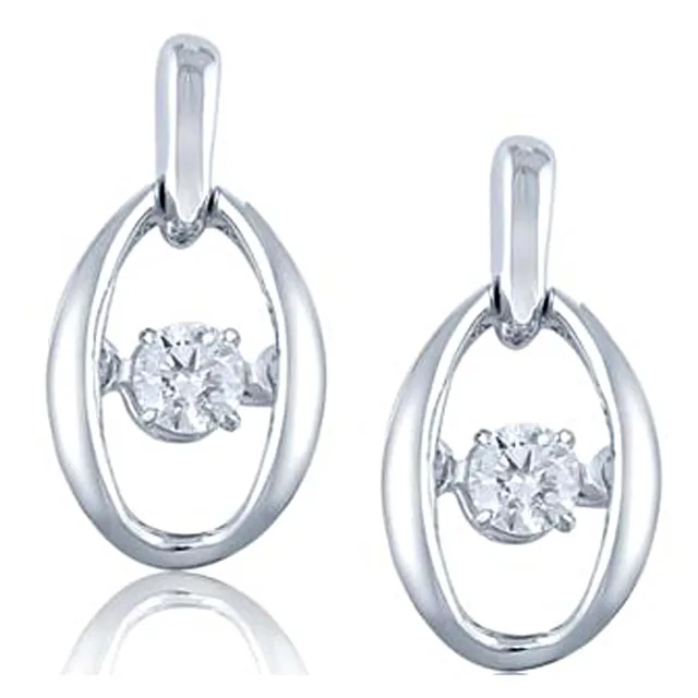 Pair of silver oval pendant earrings with suspended diamond solitaires at the center, shown with matching posts and backs.