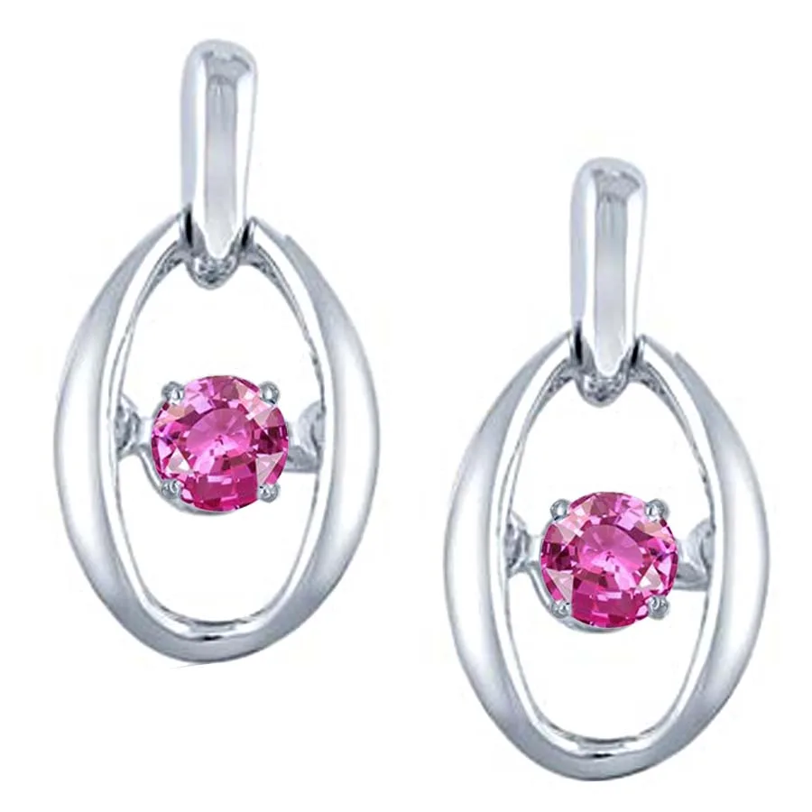 A pair of silver oval drop earrings, each featuring a bright pink faceted gemstone suspended in the center of the loop.