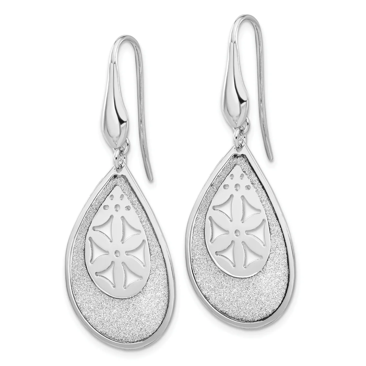 A pair of silver teardrop earrings with textured outer surfaces and polished inner ovals featuring a daisy flower design, suspended from curved wire hooks.