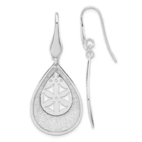 Pair of silver teardrop earrings with textured outer layer and geometric flower design on inner teardrop, suspended from curved ear wires.