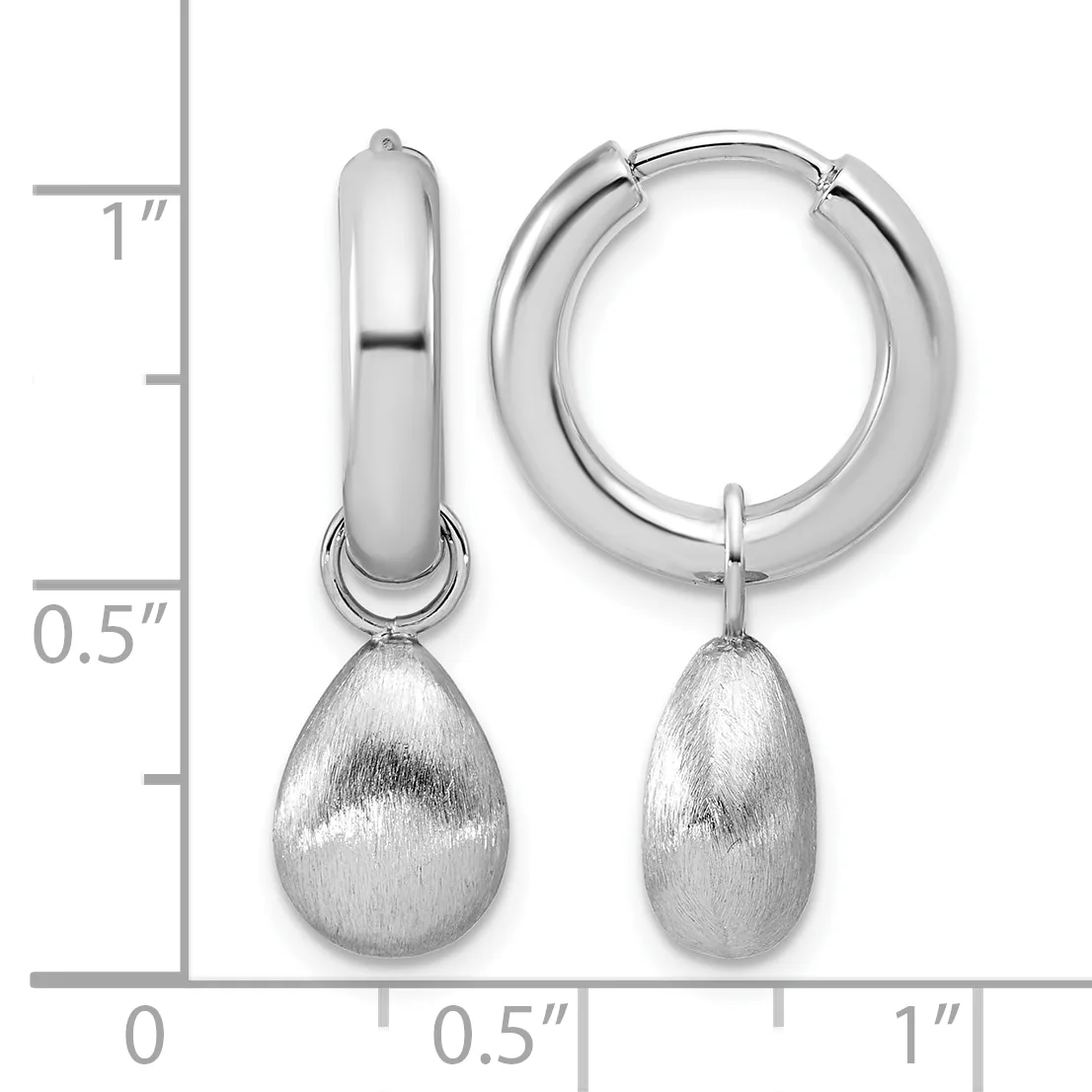 A pair of silver hoop earrings with teardrop-shaped textured pendants, displayed against a measurement scale showing approximately one inch in length.