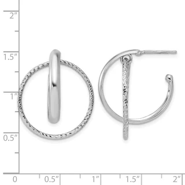 A pair of silver hoop earrings with a twisted textured outer band and polished inner band, shown against a measurement scale.