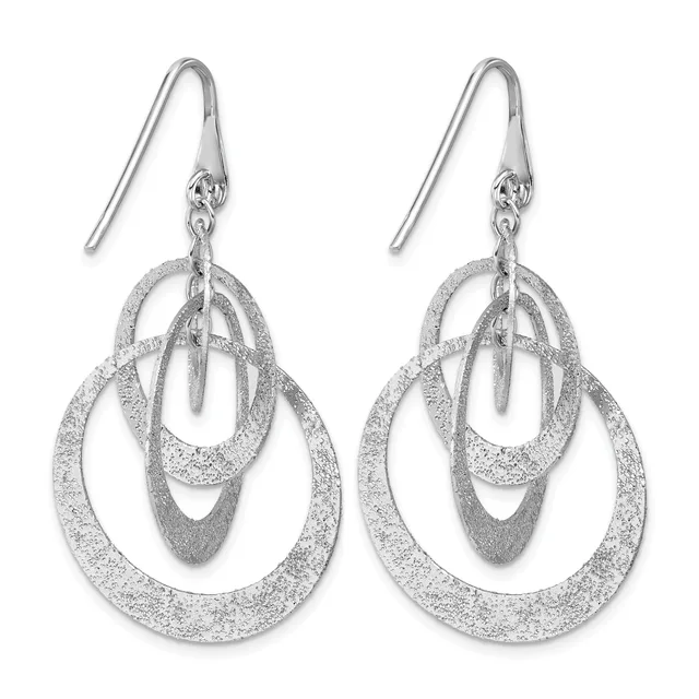 A pair of silver textured drop earrings with nested oval loops suspended from fish hook wires.