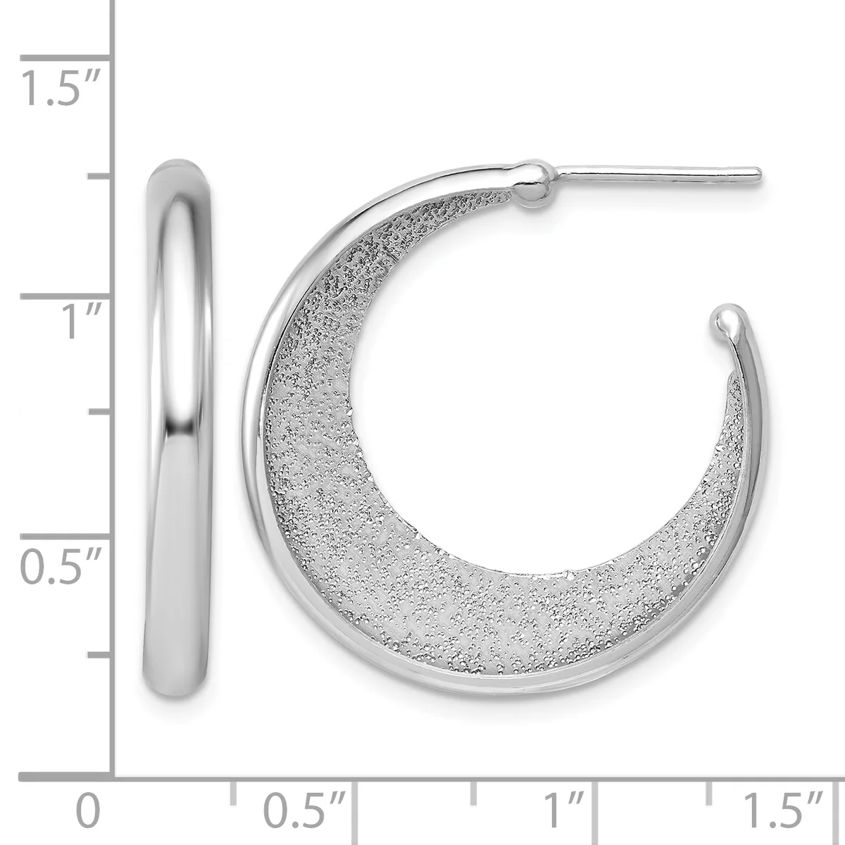 A pair of silver hoop earrings with textured surfaces, shown next to a ruler indicating they are approximately one inch in diameter.